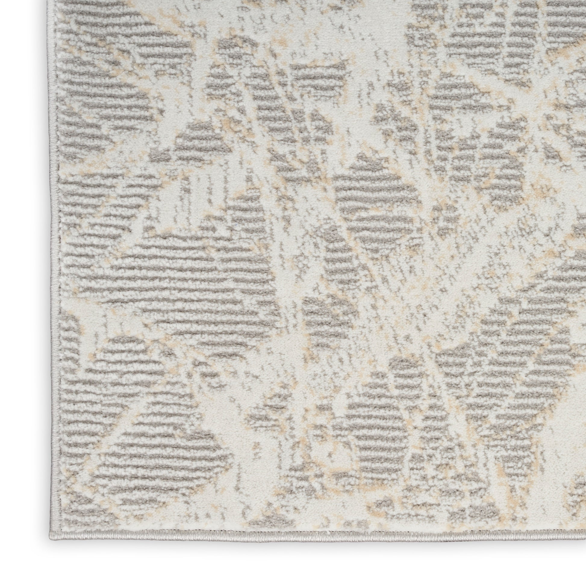 Beige and gray abstract geometric area rug with plush tufted pile and bound edges.