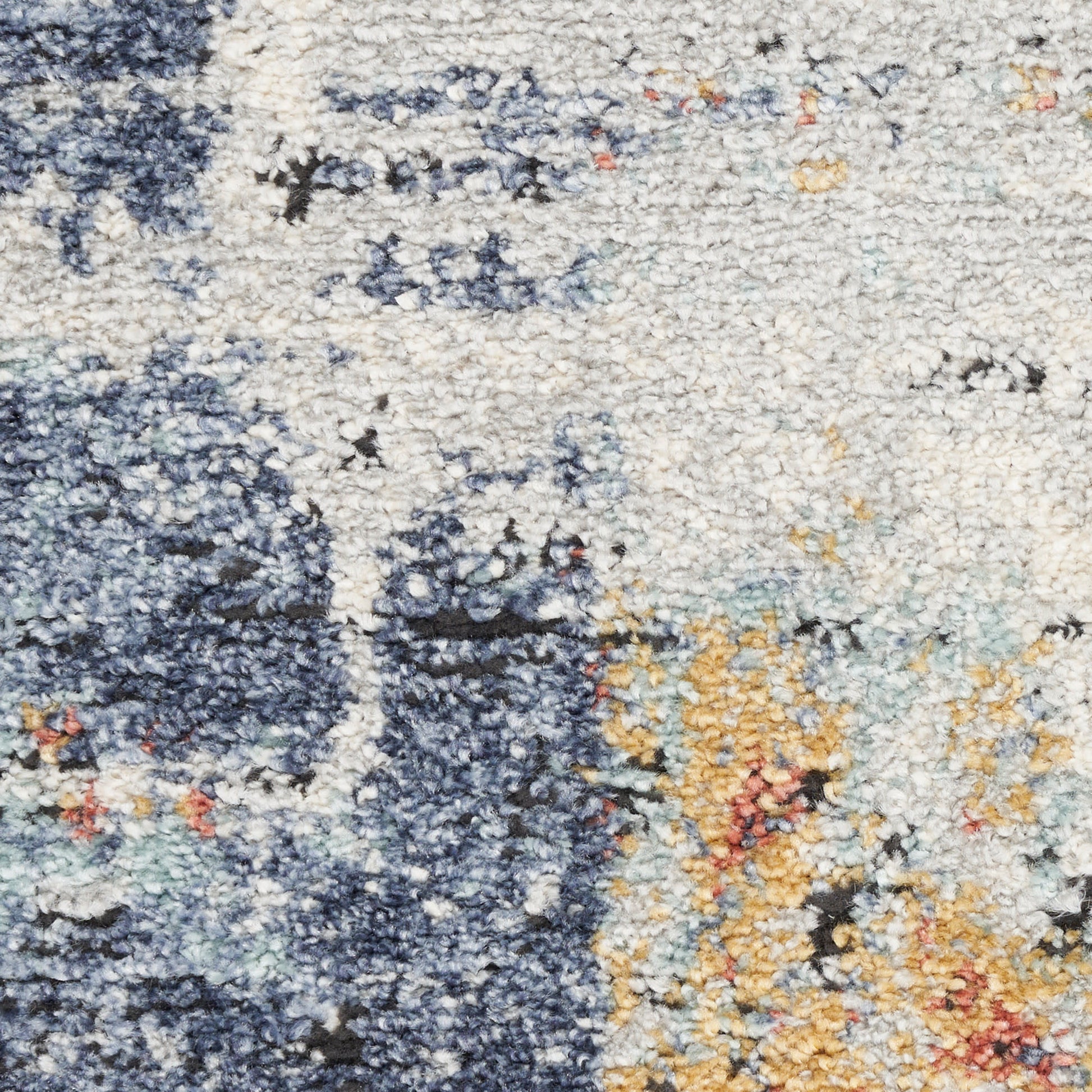 Shaggy abstract area rug in navy, ivory, light blue and mustard; plush tufted texture.