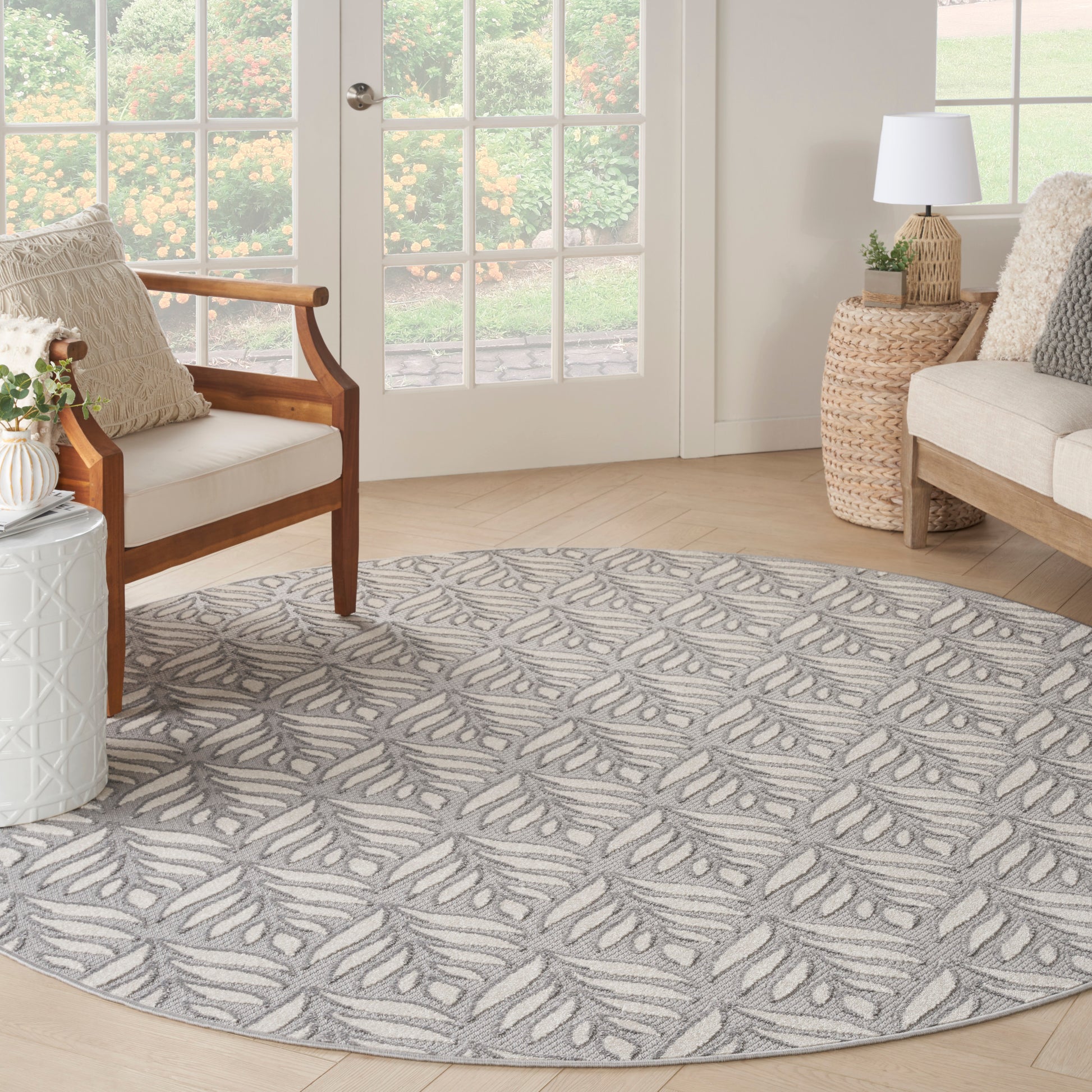 Round gray and white leaf-pattern area rug with soft textured pile for cozy living room decor