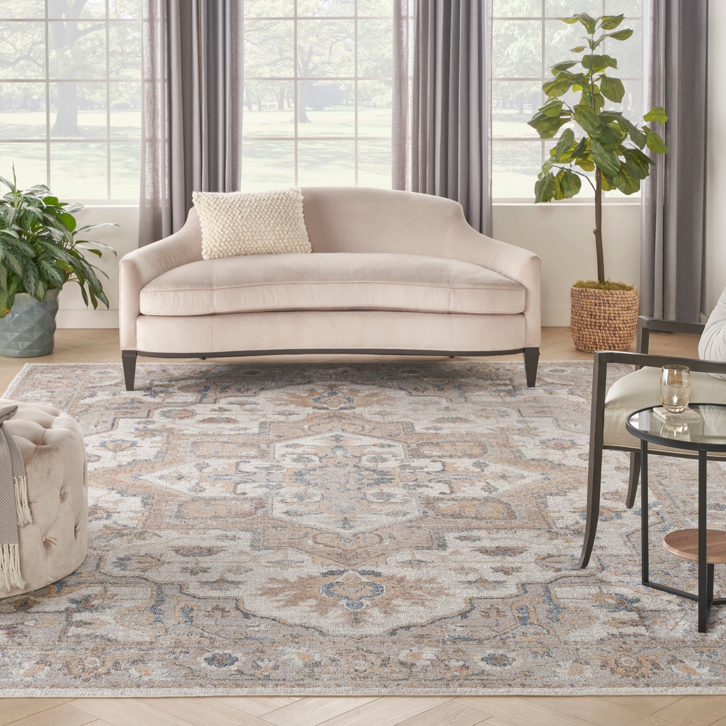 Beige-blue patterned vintage rug (8' x 10') on a sunlit living room floor.