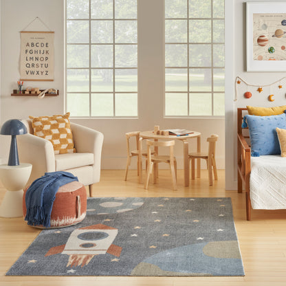 Cozy kid's room with light wood furniture, alphabet poster, round table, cream chair, space-themed rug and blue accents.