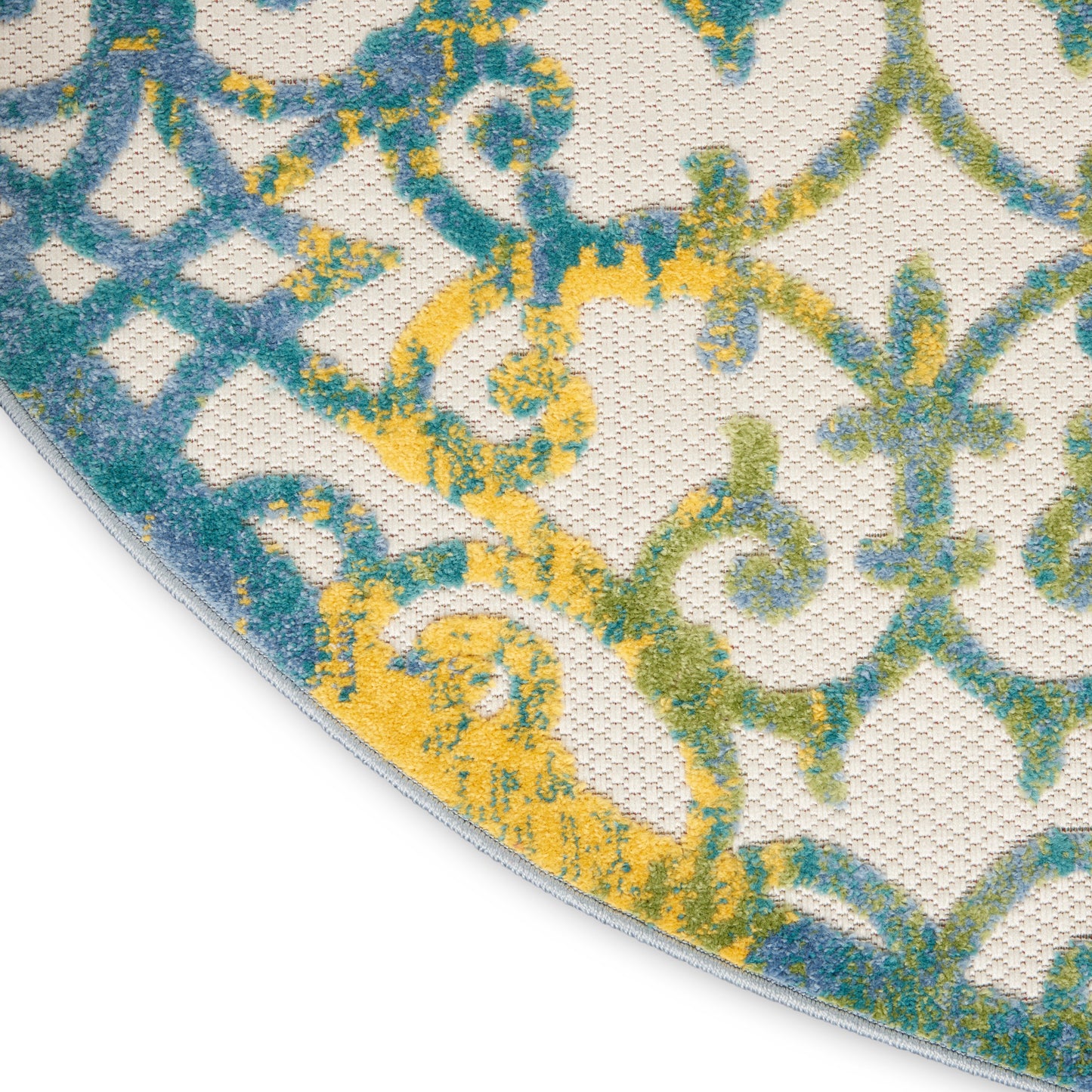 Round woven rug with damask-inspired blue, teal & yellow pattern on ivory background; curved edge visible.