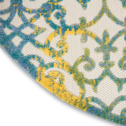 Round woven rug with damask-inspired blue, teal & yellow pattern on ivory background; curved edge visible.