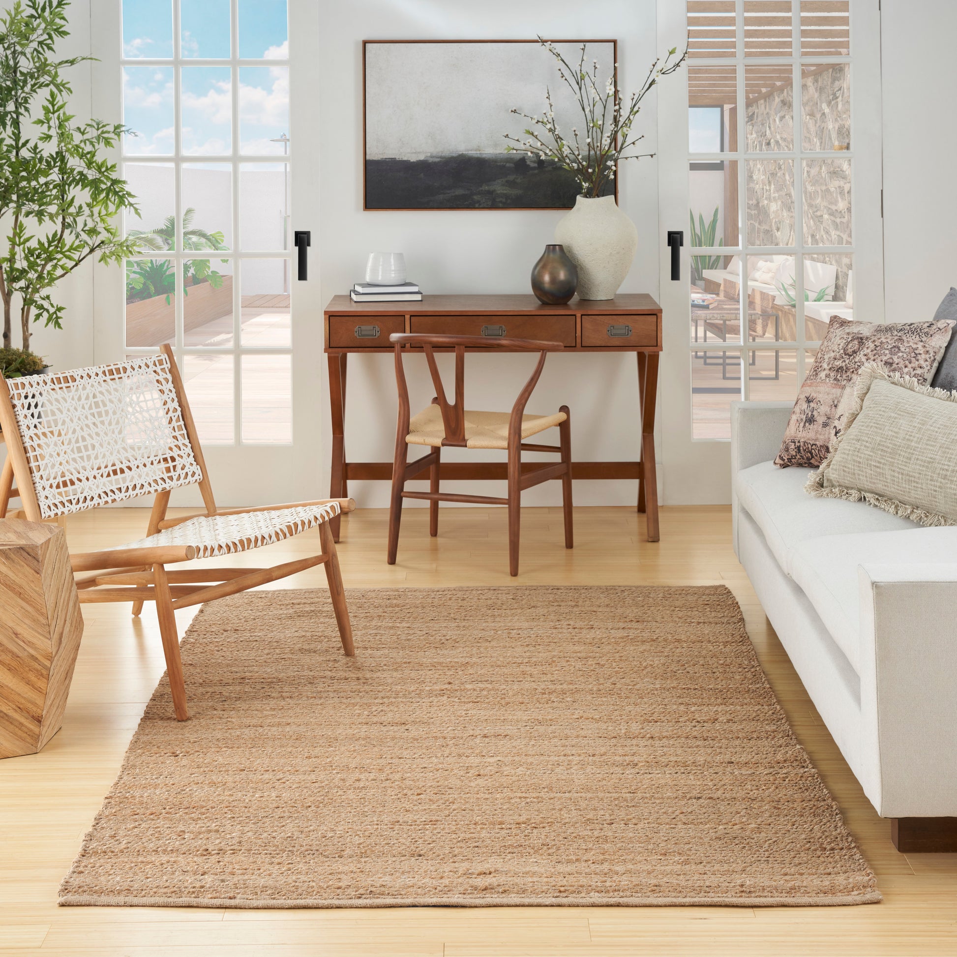 Farmhouse-style jute rug in a bright living room with greenery.