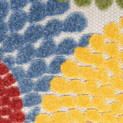 Close-up of a plush tufted rug with blue, yellow and red circular clusters on a white lattice background; cozy floor decor.