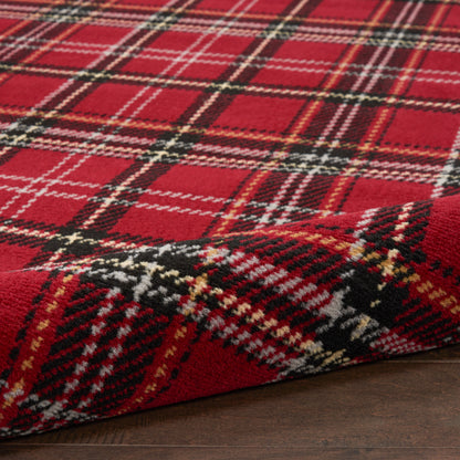 Red tartan wool rug runner, 8' long, with black, white and yellow accents, folded at a corner on a dark wood floor.