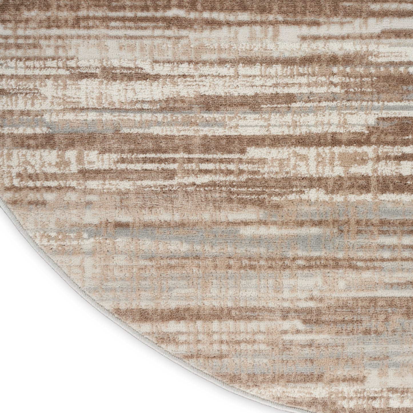 Round beige rug with tan and grey brushstroke pattern; soft textured surface for modern living spaces.