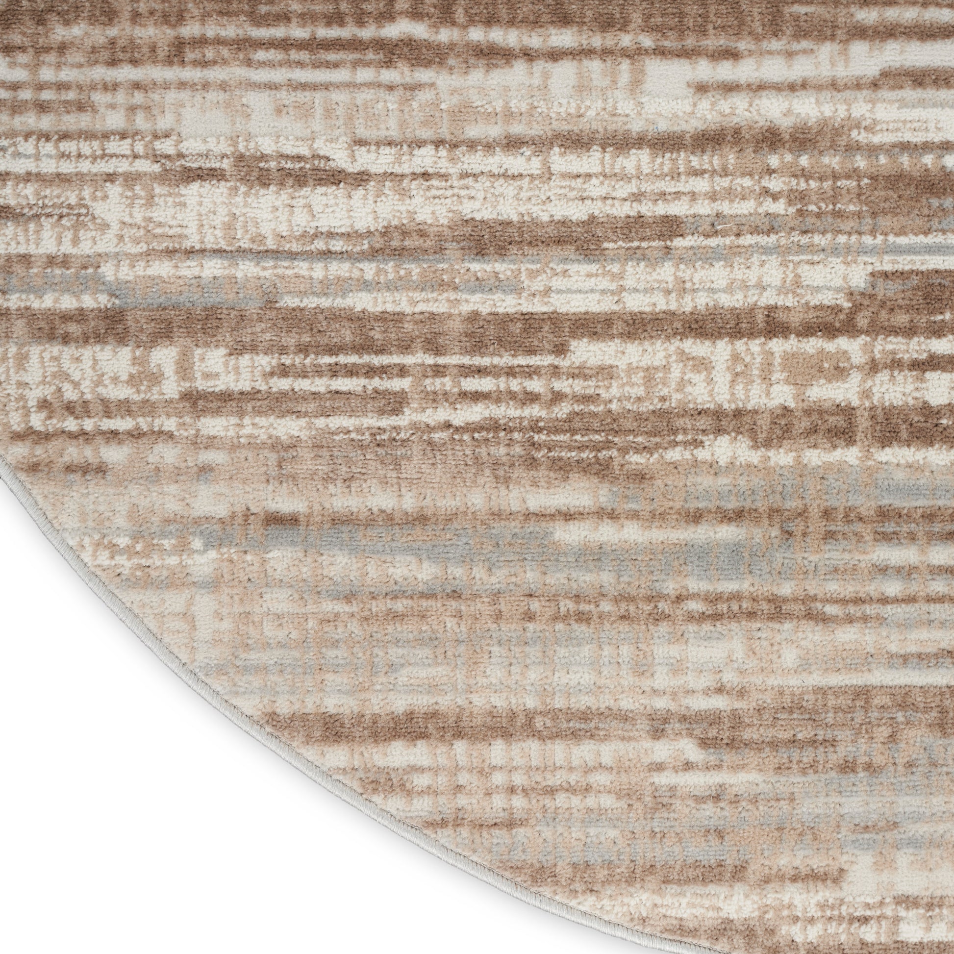 Round beige rug with tan and grey brushstroke pattern; soft textured surface for modern living spaces.