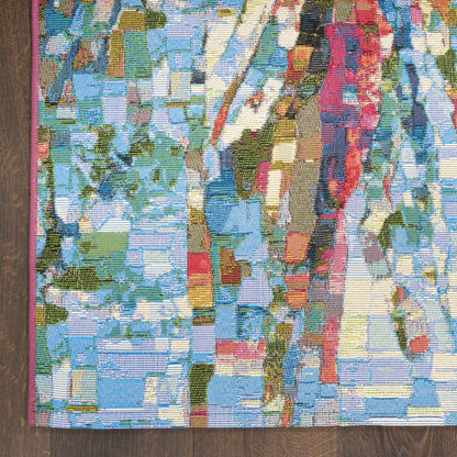 Vibrant abstract woven rug with multicolor mosaic blocks in blues, greens, yellows and pinks; pink edge trim.