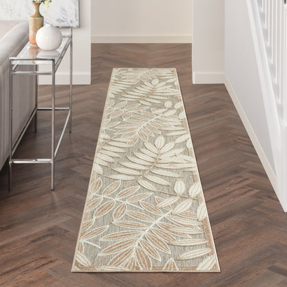 Long flat-weave hallway runner rug with beige leaf motif on gray background.