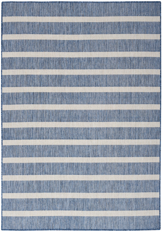 Denim-blue woven rug with bold off-white horizontal stripes, rectangular, casual coastal style.