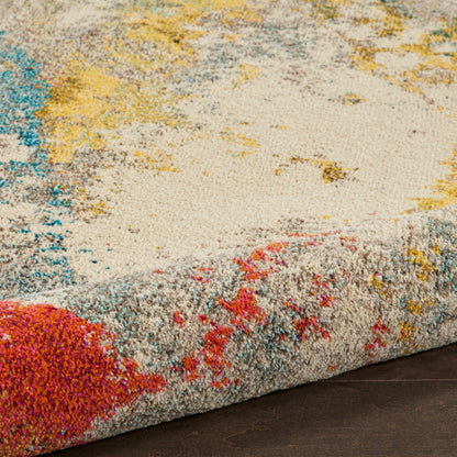 Close-up of a plush rug with cream base & bright teal, yellow, pink accents; thick pile & rolled edge.