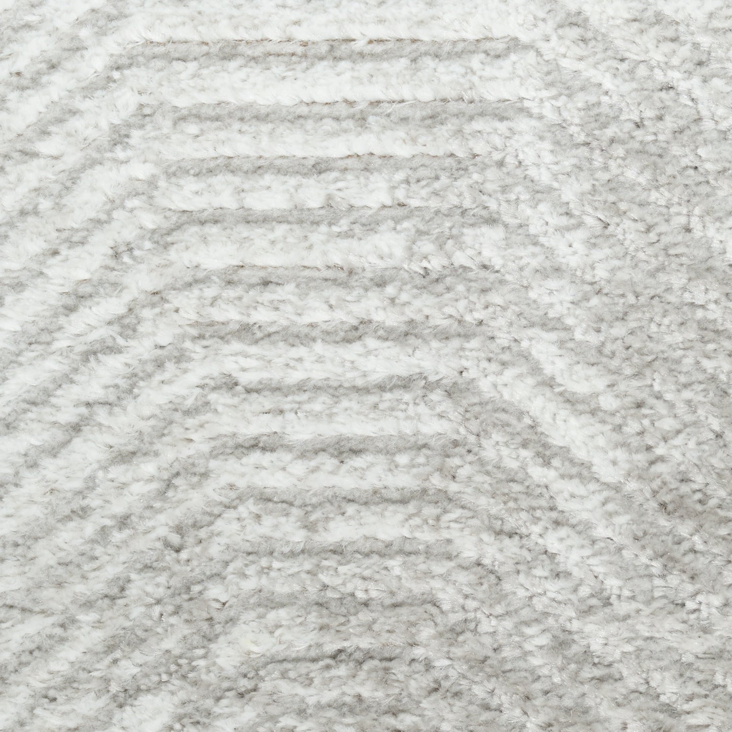 Light gray shag rug with plush pile and subtle chevron wave pattern