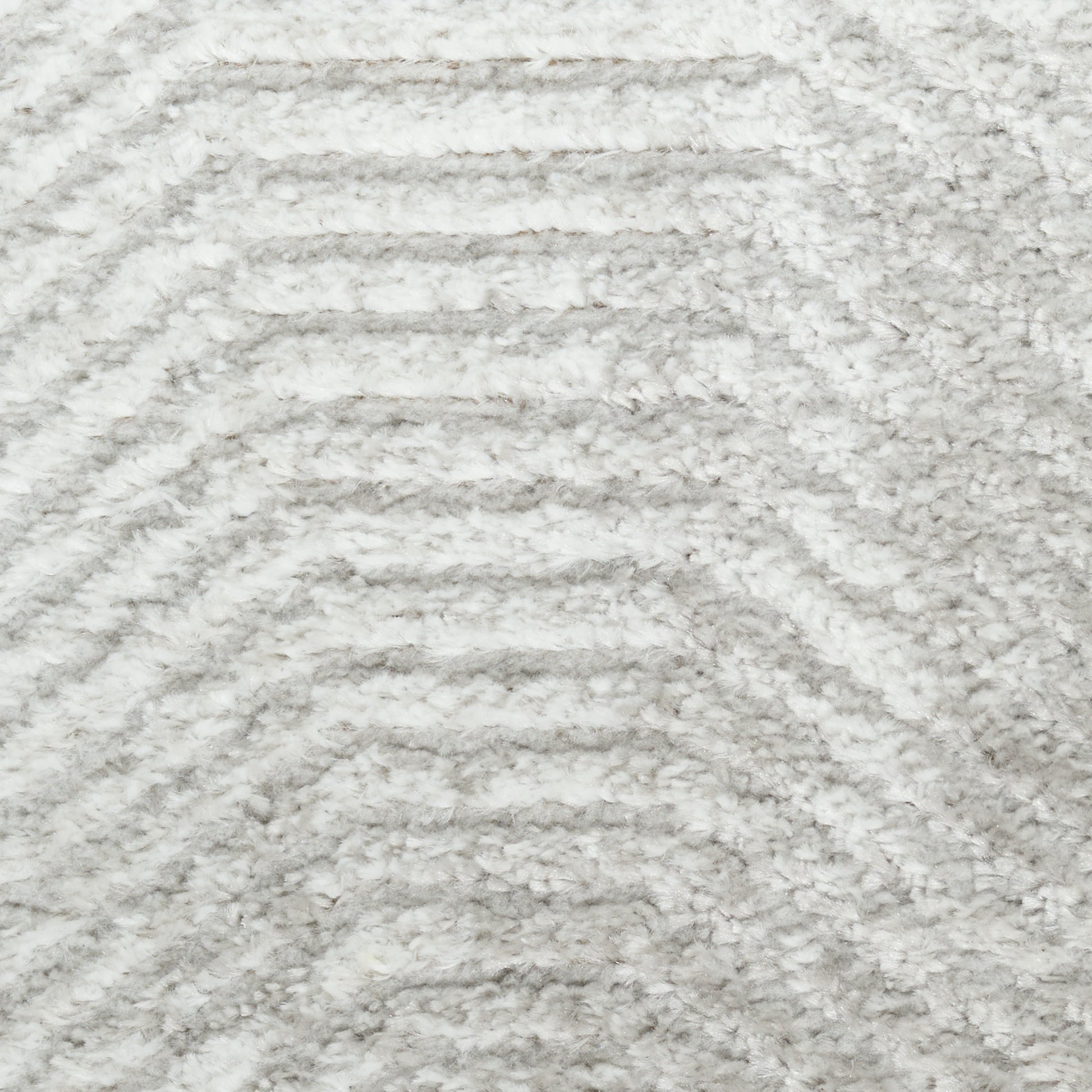 Light gray shag rug with plush pile and subtle chevron wave pattern
