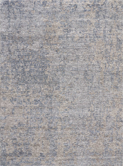 Blue and beige distressed-pattern area rug with abstract vintage print and woven texture.