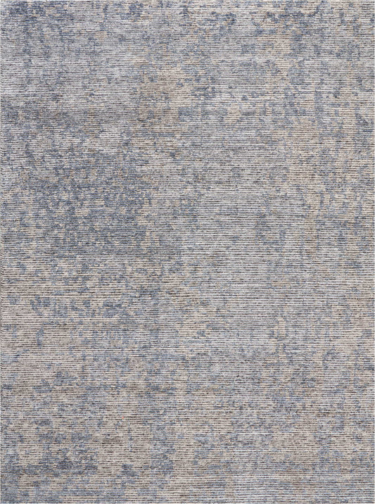 Blue and beige distressed-pattern area rug with abstract vintage print and woven texture.