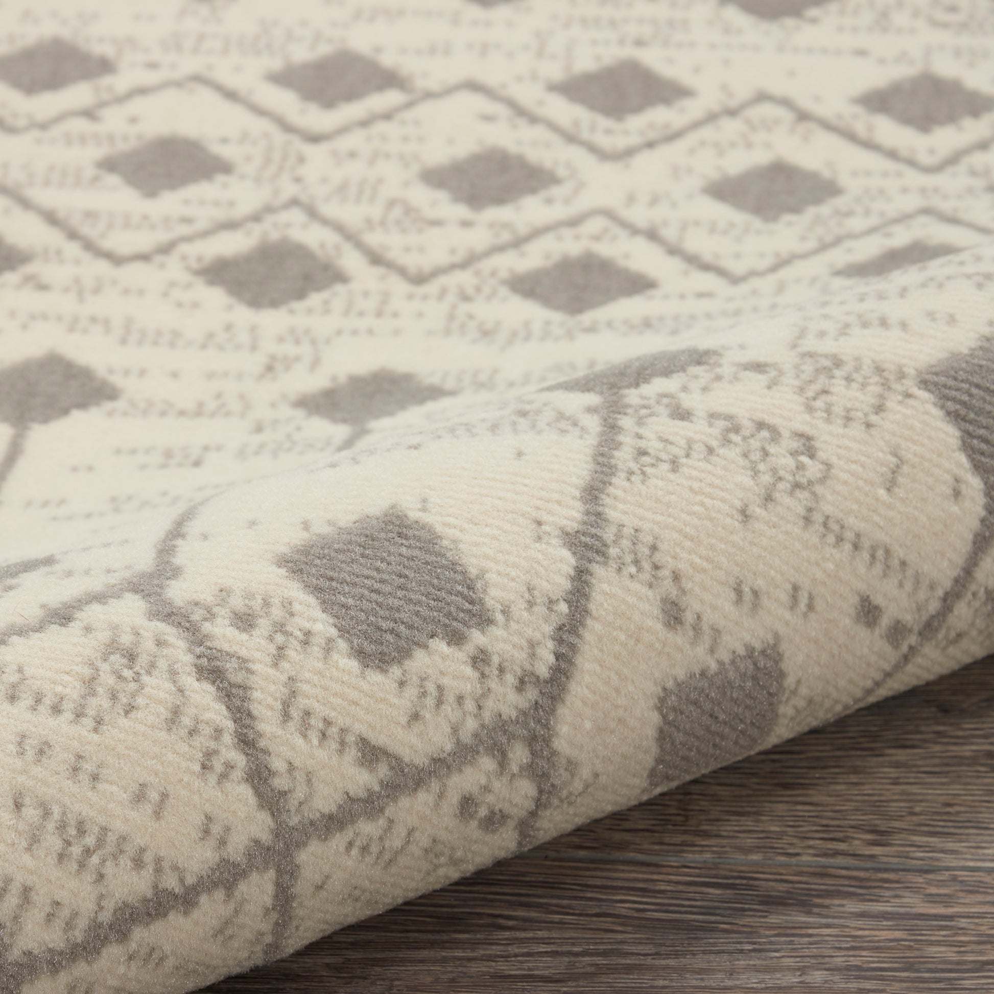 Beige woven rug with a gray diamond lattice pattern; soft textured fabric, decorative floor or couch accent, size 9' x 12'.