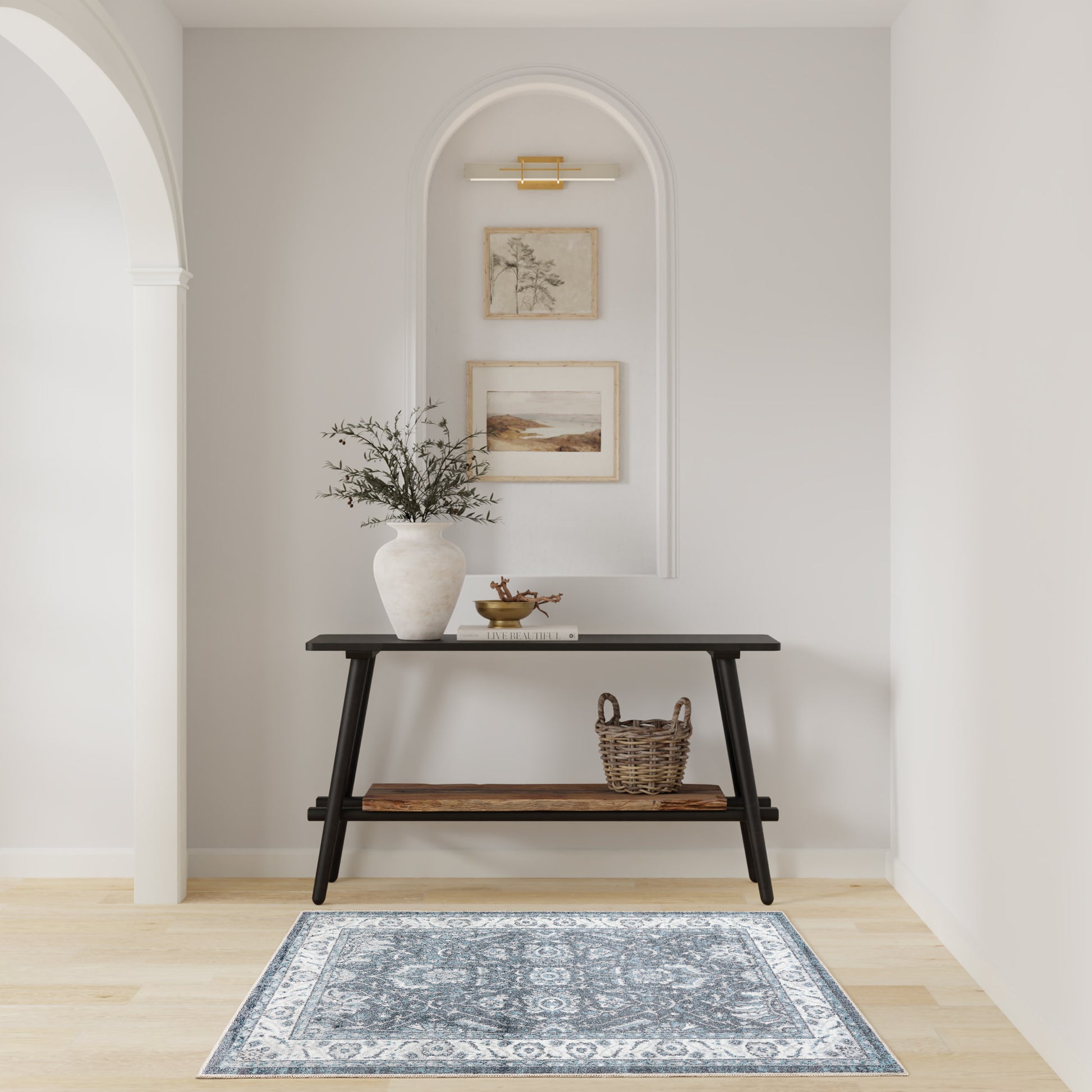 Black console with wood shelves in an arched wall niche; vase with branches, basket, framed art, and blue rug.