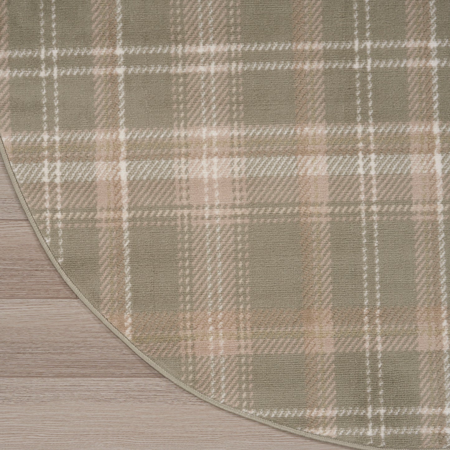 Beige plaid rug with tan and white checks, curved edge, soft woven texture on wood floor.