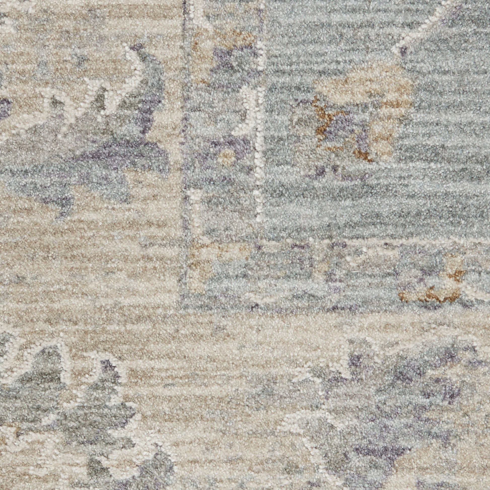 Neutral distressed area rug with faded floral motifs in beige, gray & lavender; woven texture.