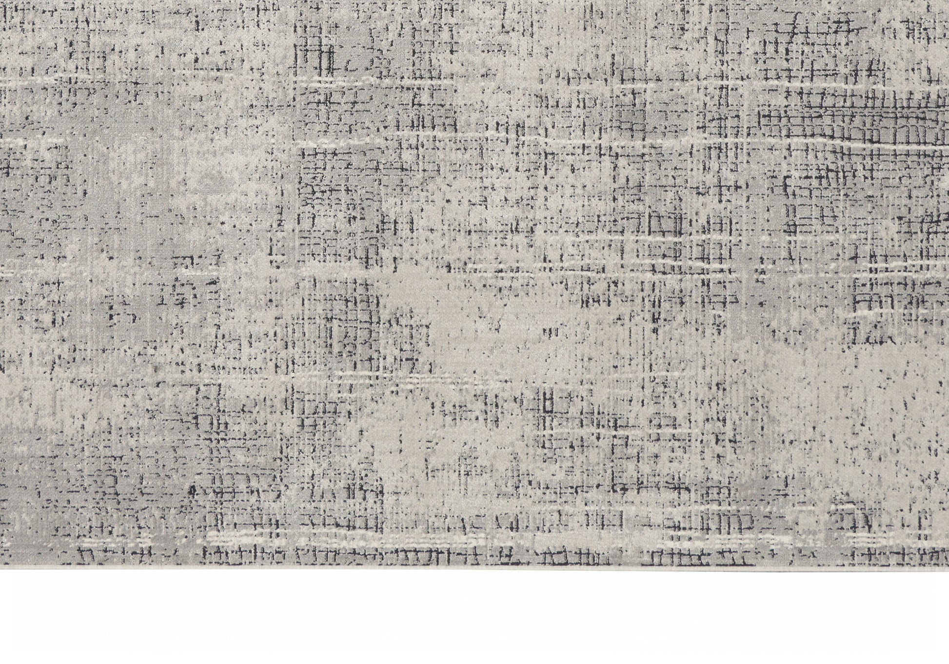 Light gray distressed area rug with abstract textural pattern; rectangular, modern home decor.
