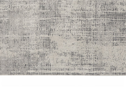 Light gray distressed area rug with abstract textural pattern; rectangular, modern home decor.