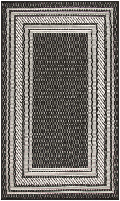 Black and white rectangular area rug with layered borders and diagonal-striped outer frame modern geometric design