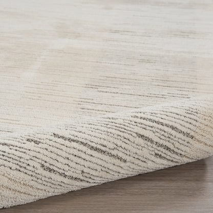 Beige textured area rug with subtle brown wave lines on a light wooden floor.