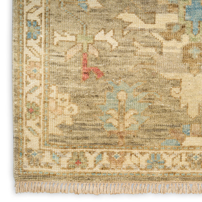 Beige oriental-style woven rug with blue and cream motifs; subtle red accents, decorative border, and fringe.