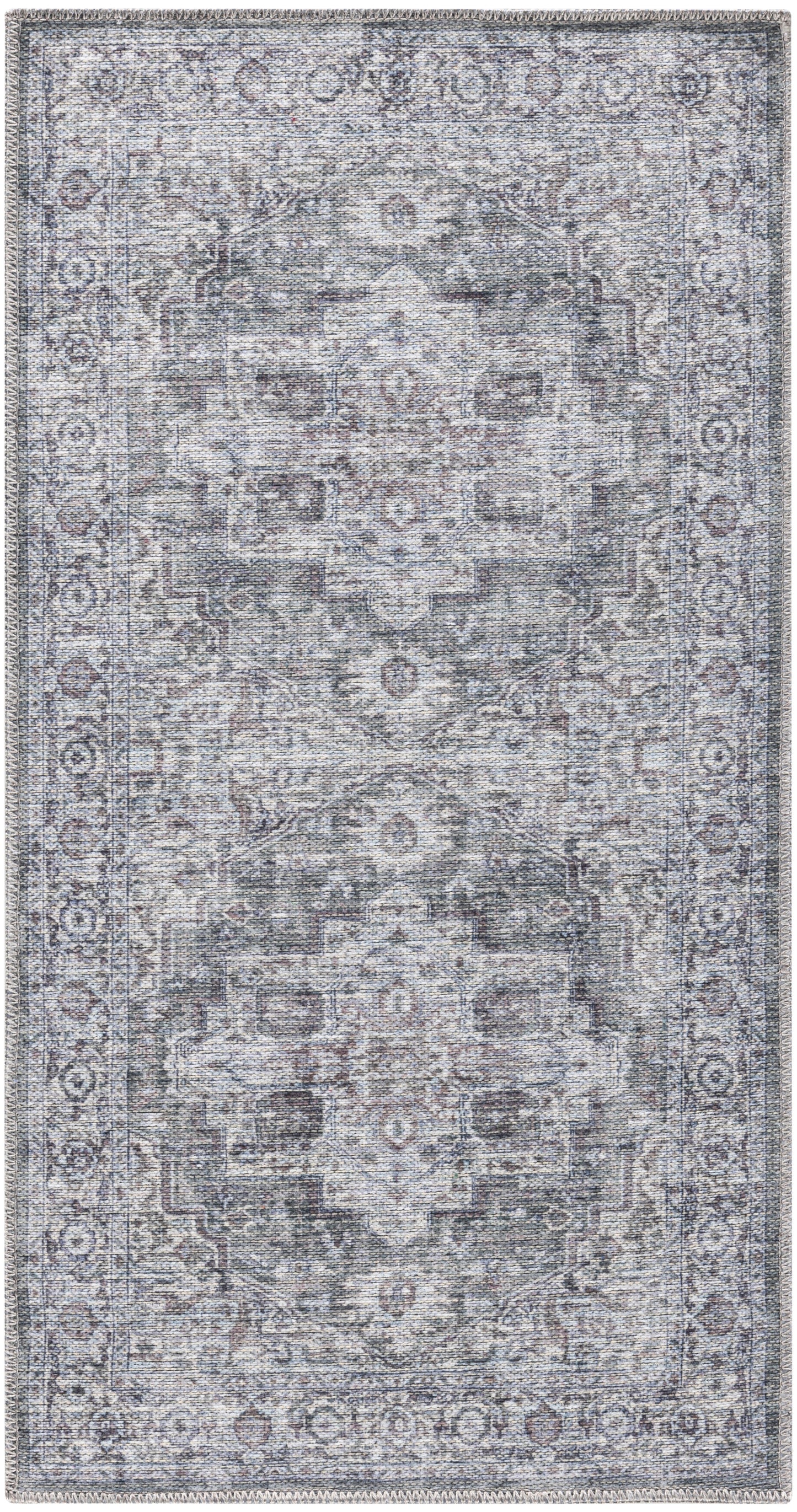 Distressed blue-gray oriental area rug with faded central medallion, ivory/charcoal motifs and fringed edges.