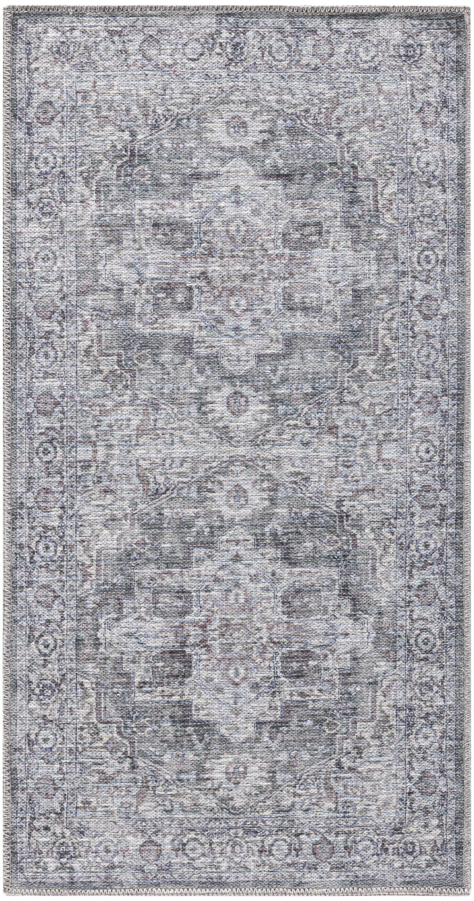 Distressed blue-gray oriental area rug with faded central medallion, ivory/charcoal motifs and fringed edges.