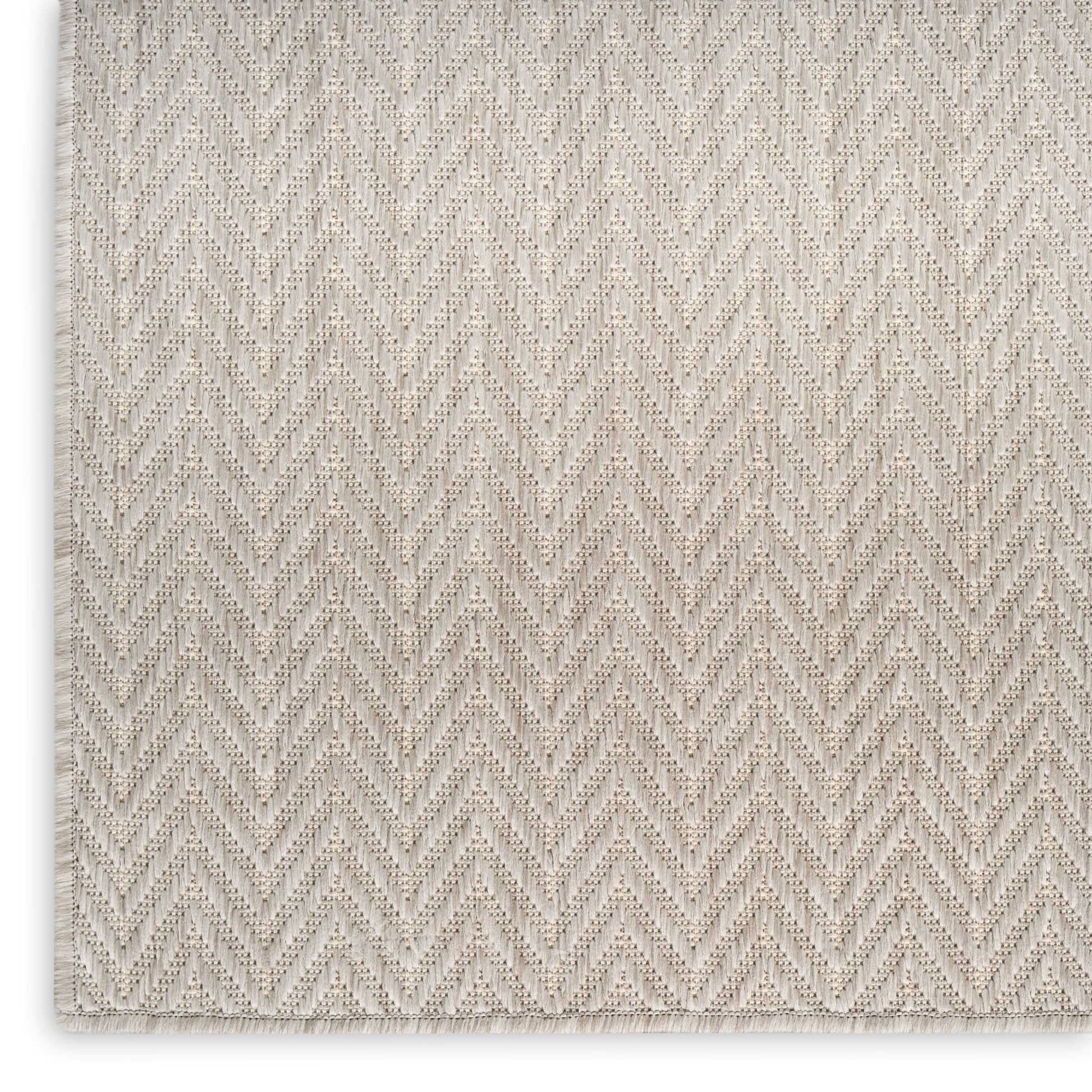 Beige chevron-weave rug with subtle zigzag texture, soft and neutral.