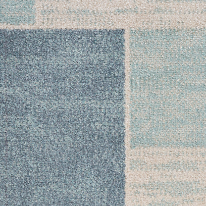 Geometric patchwork runner rug in navy, sky blue and cream; soft, textured finish for modern decor.