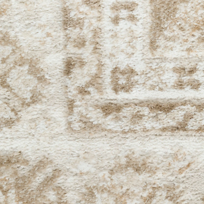 Cream-tan plush shag rug with a subtle geometric pattern; soft, textured surface for cozy living room decor.
