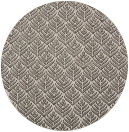 Round rug in taupe with a gray botanical leaf pattern; textured woven fabric for modern home decor.