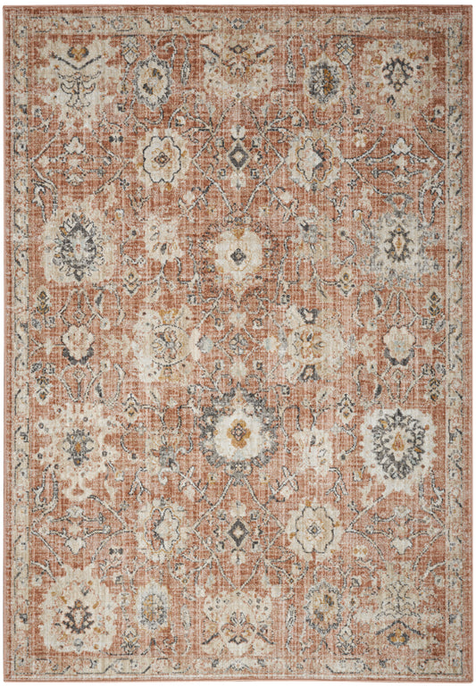 Rust-red oriental-style rug with distressed cream floral medallions, blue-gray accents and an ornate border.