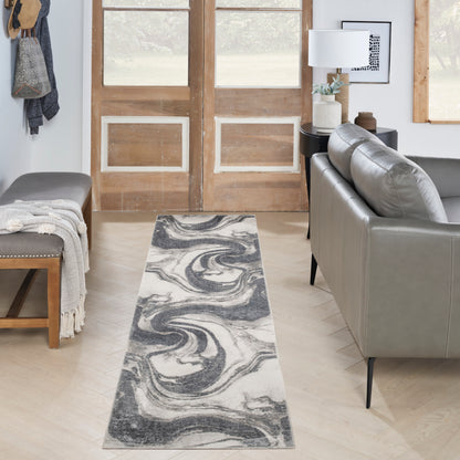 Gray & white marble swirl runner rug on light wood floor in a living room with sofa, bench, coat rack and entry doors.