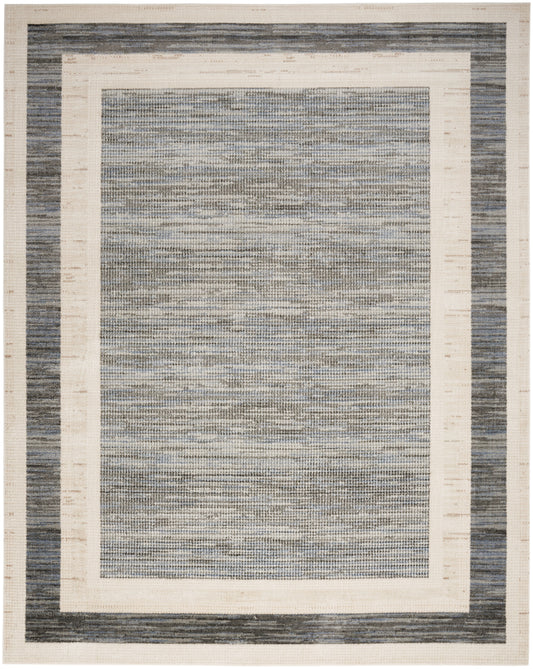 Rectangular woven area rug with navy blue outer border, cream inner frame, and a blue-gray textured center.