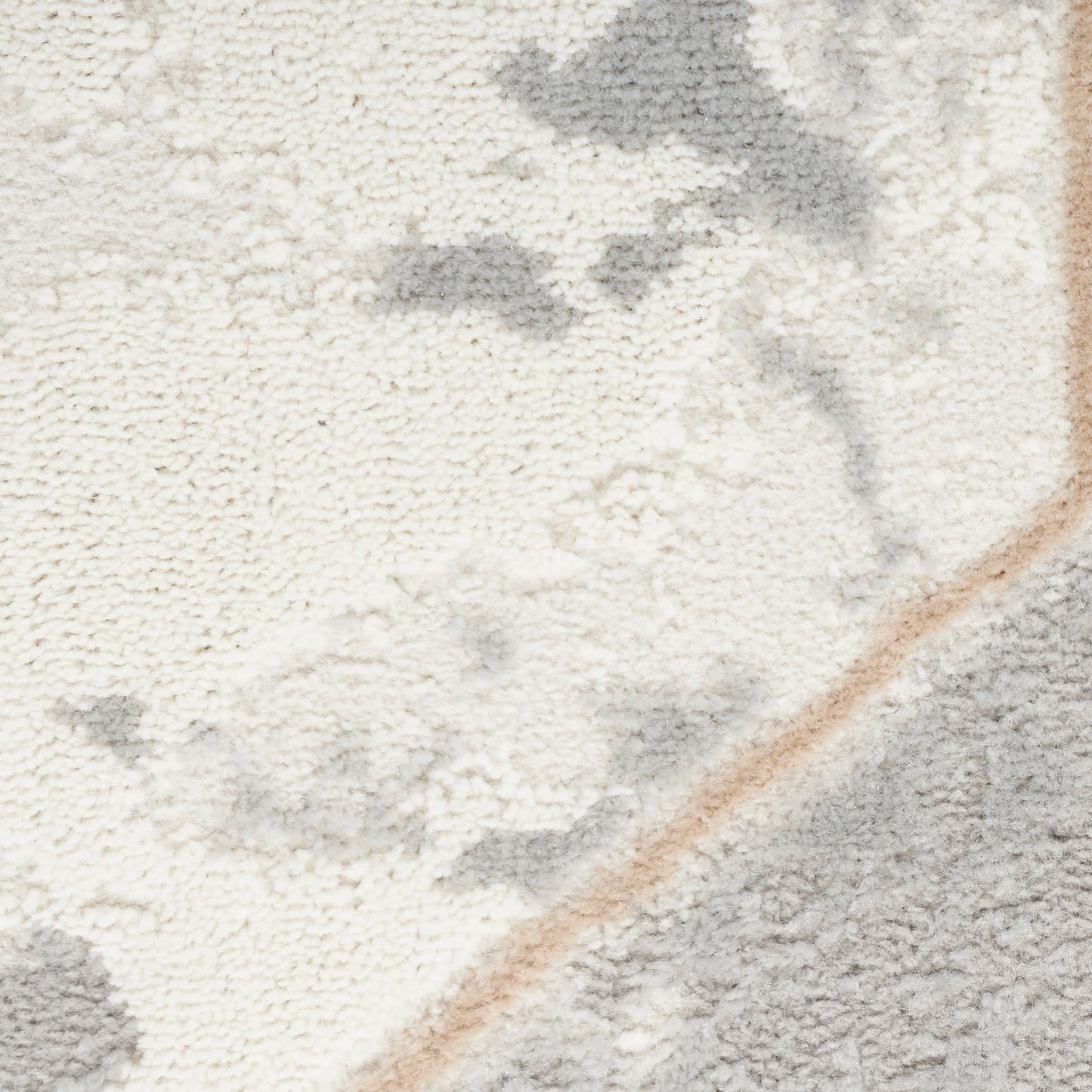 Close-up of a plush cream and gray rug with a tan diagonal border.