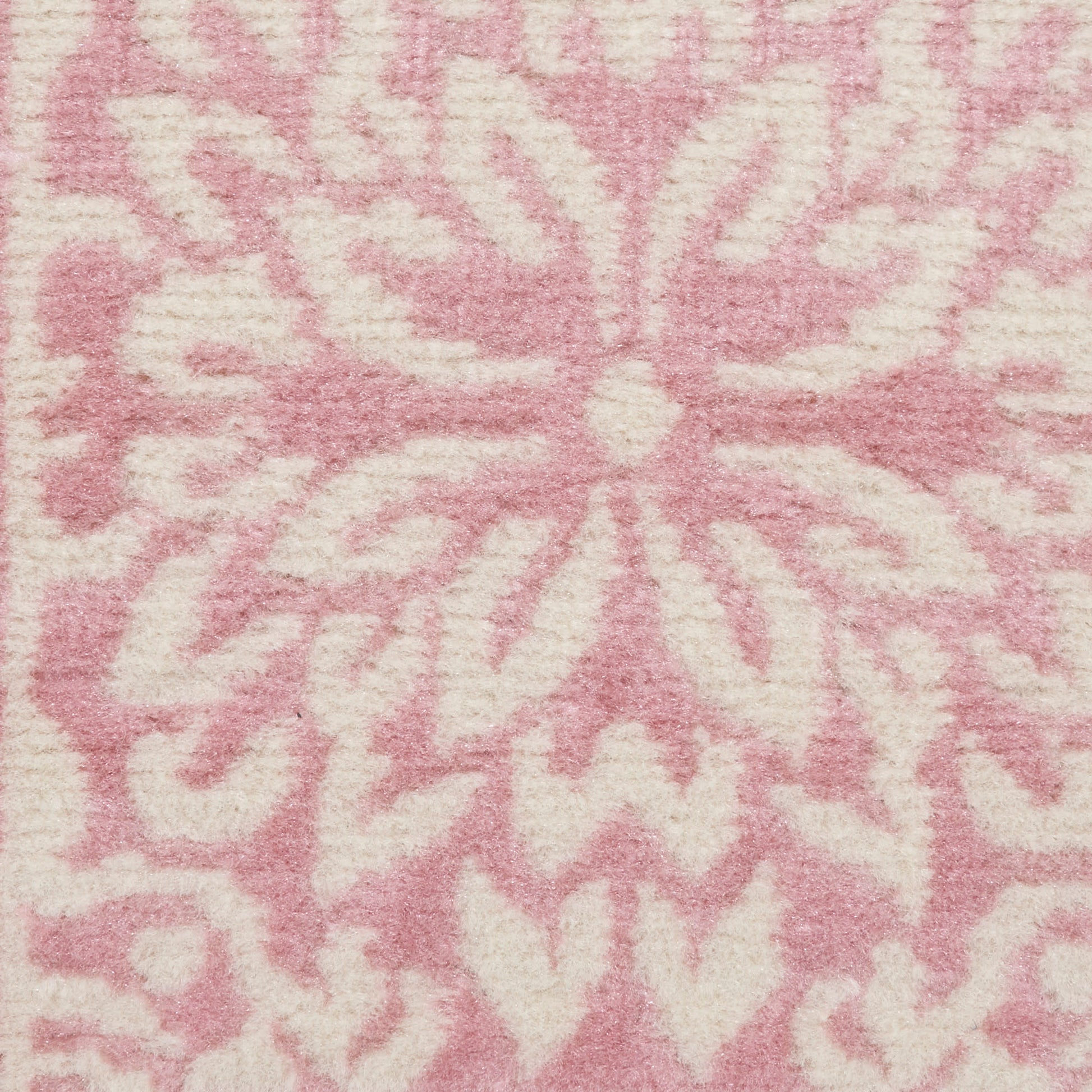 Soft pink runner rug with a white floral starburst motif in plush woven texture, 6' long.