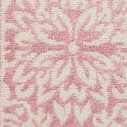 Soft pink runner rug with a white floral starburst motif in plush woven texture, 6' long.