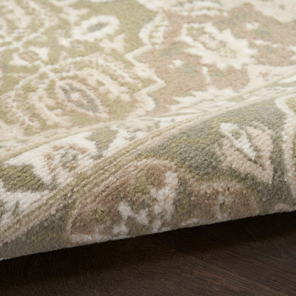 Soft, neutral-toned area rug with traditional ivory and sage pattern; plush pile on a dark wood floor.