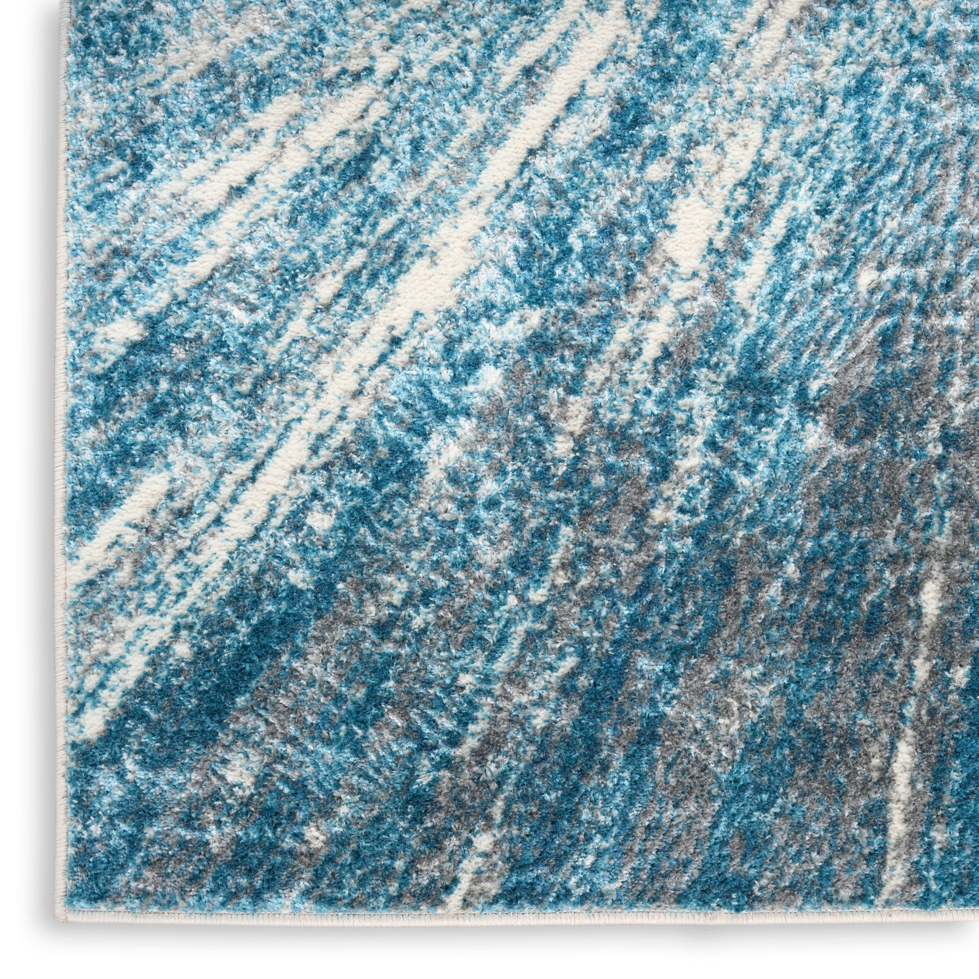 Blue and white abstract diagonal striped rug with plush texture, rectangular.