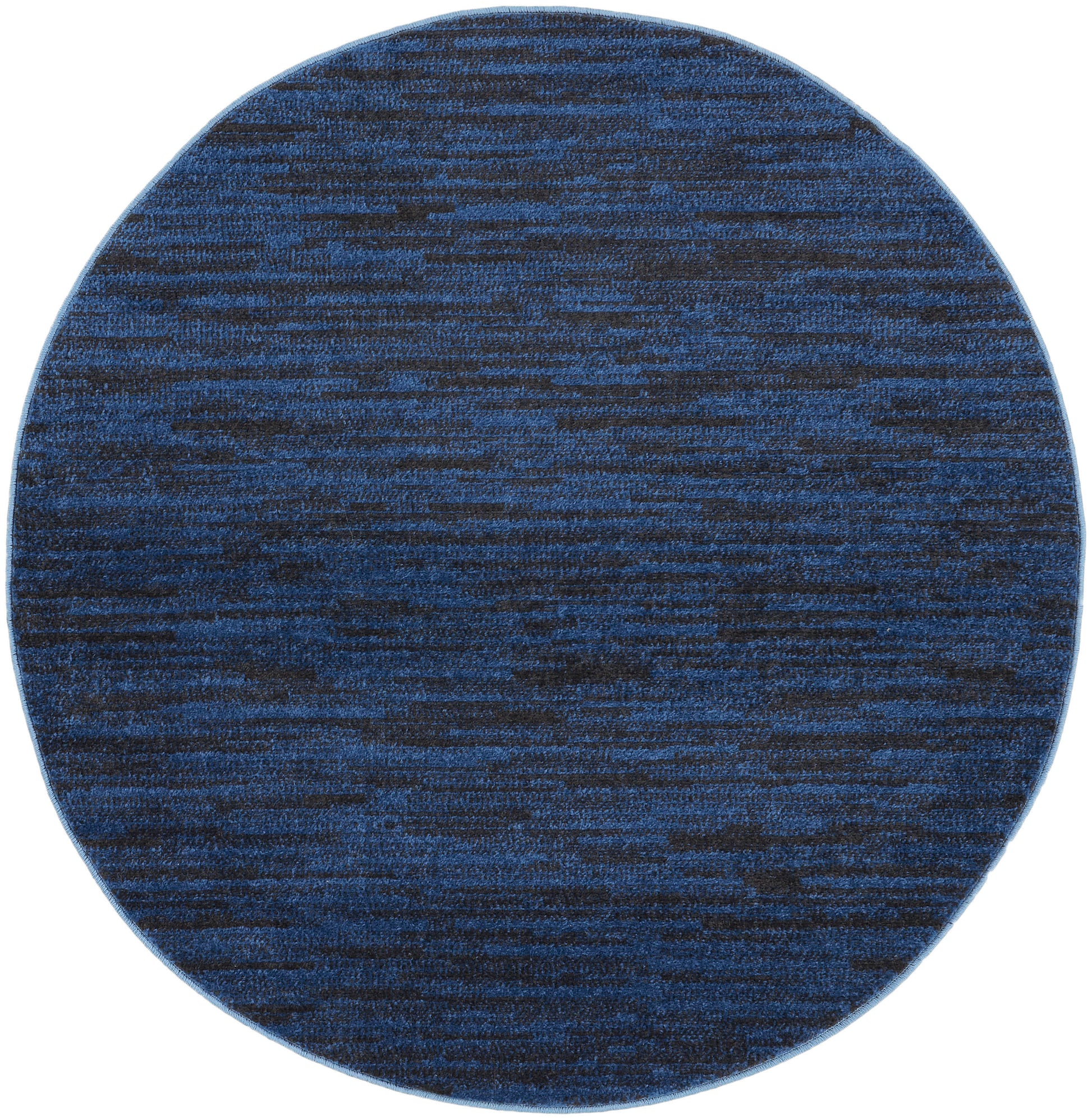 Round blue rug with navy and cobalt marled pattern, woven texture for modern living spaces.