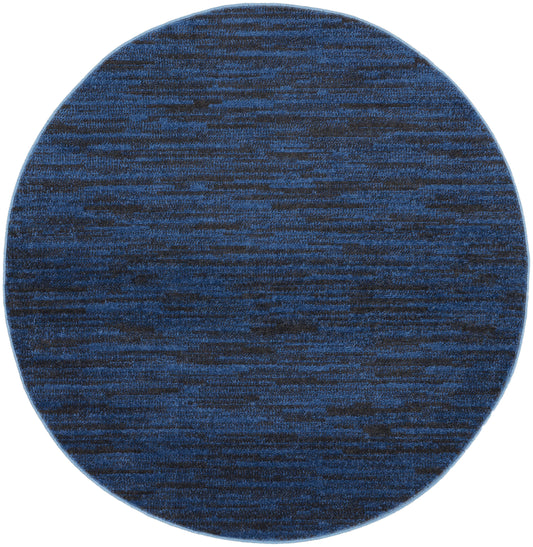 Round blue rug with navy and cobalt marled pattern, woven texture for modern living spaces.