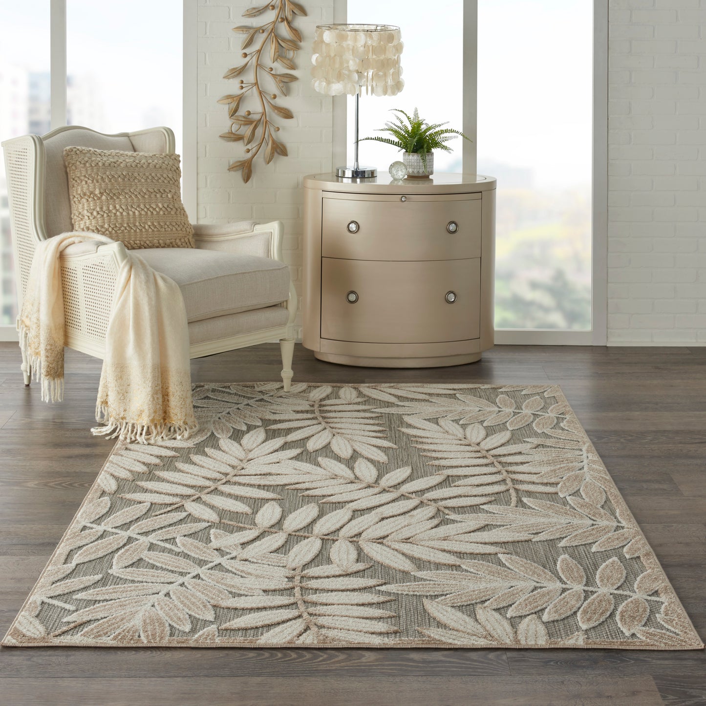 Rectangular beige area rug with light palm leaf pattern in taupe and cream tones, woven texture for living room.