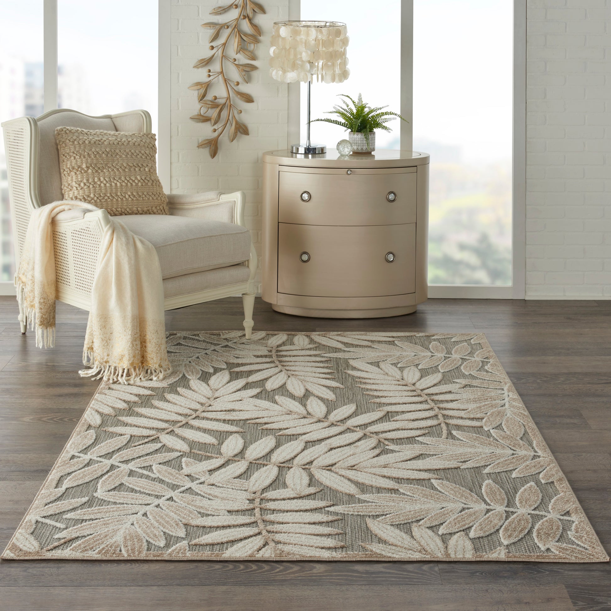 Rectangular beige area rug with light palm leaf pattern in taupe and cream tones, woven texture for living room.