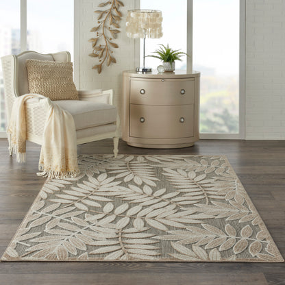 Rectangular beige area rug with light palm leaf pattern in taupe and cream tones, woven texture for living room.