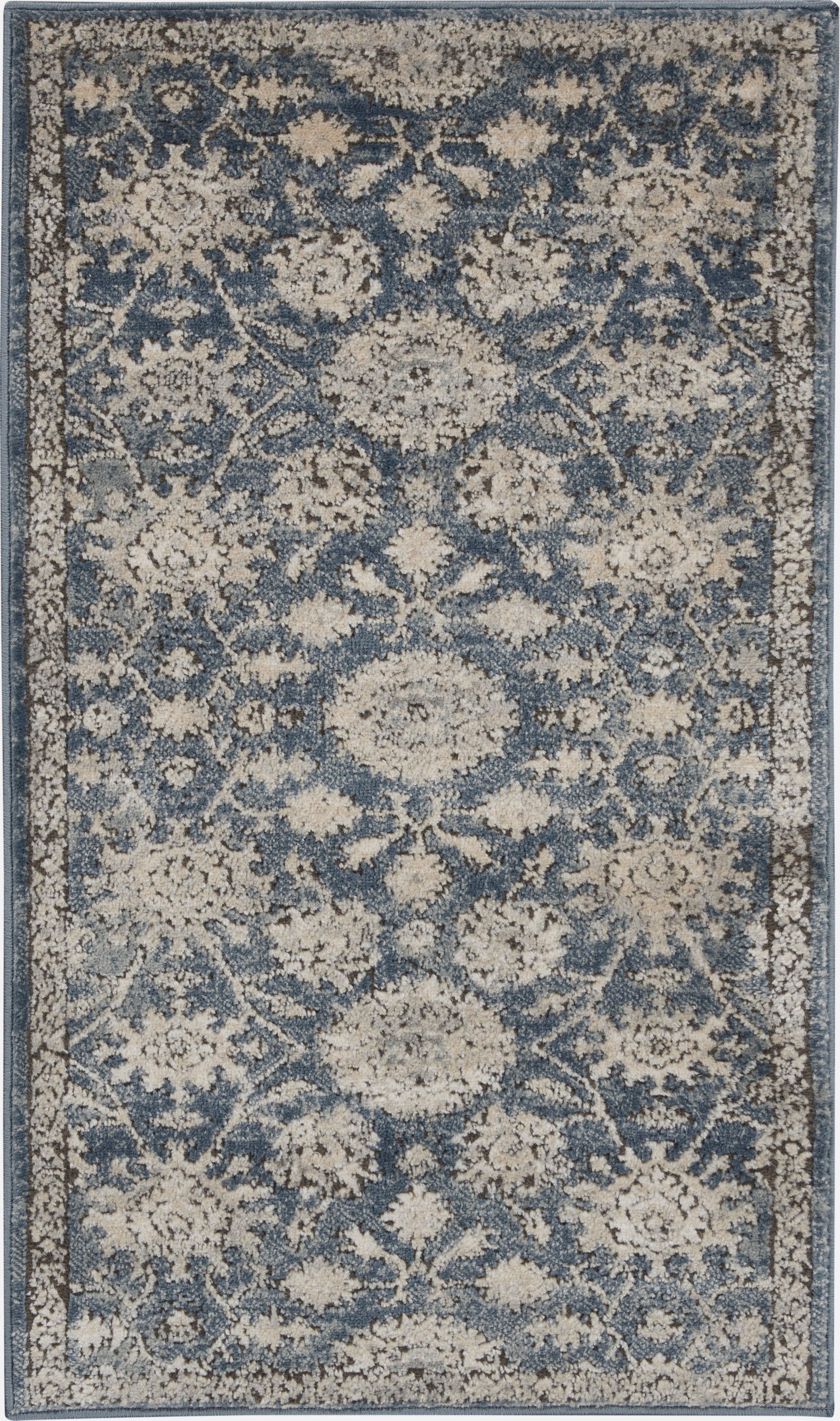 Rectangular blue and beige distressed floral rug; woven, traditional Persian-inspired medallion pattern for living room.