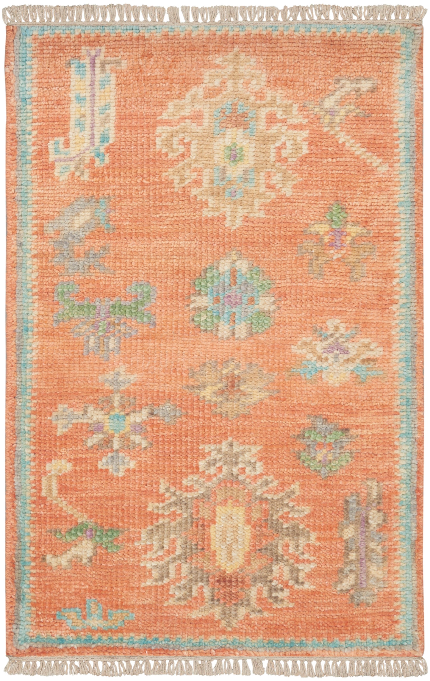 Rectangular orange wool rug with pastel floral/medallion motifs, ivory, blue and green accents; blue border and fringe.